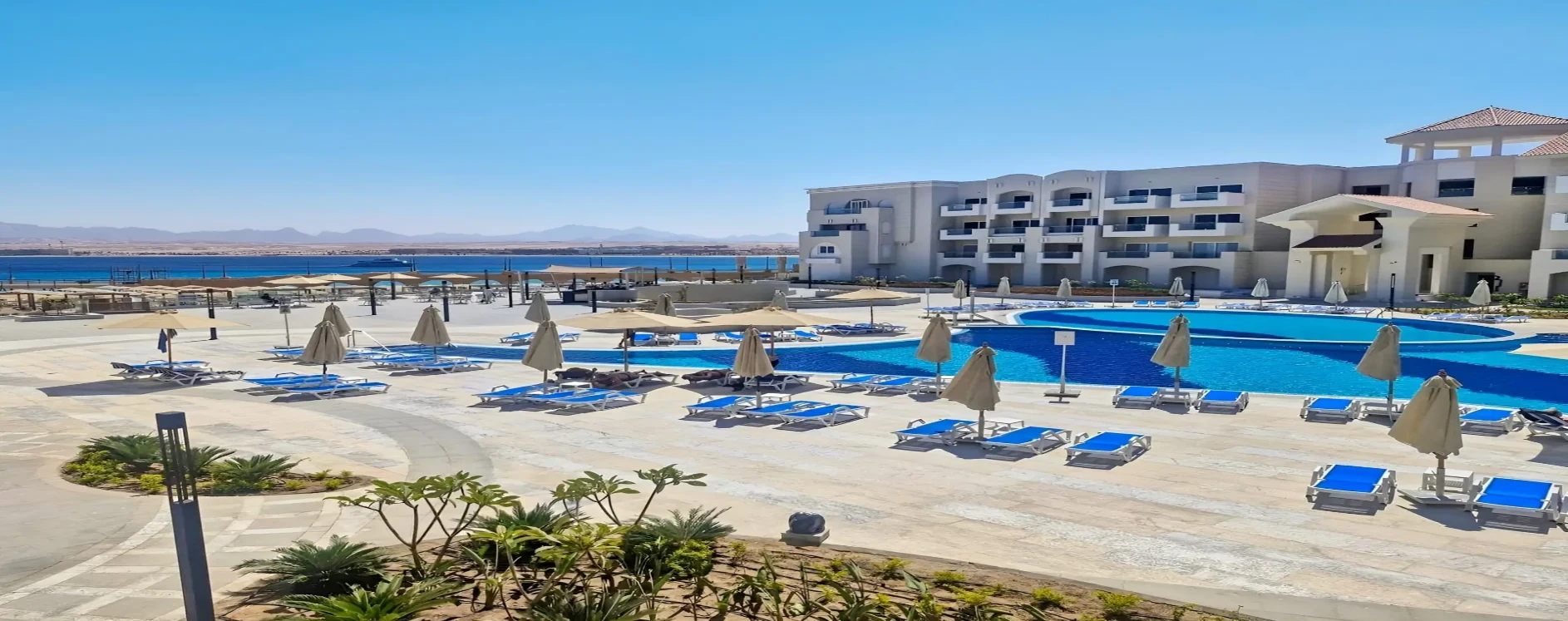 Wide view across the pools and grounds at Serenity Sky Arc